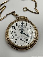 Front view of watch face and chain laid flat