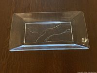 Top-down view of clear glass serving tray showing frosted bottom and rectangular shape.