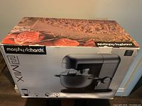 Box of the Morphy Richards Food Fusion heavy duty kitchen machine showing front view with image of mixer and stainless steel bowl.