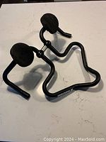 Top-down view of the ergonomic black aluminum aero handlebars showing armrests and handle shape.