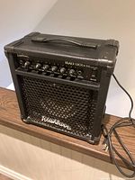 Front view of black Washburn Bad Dog BD12R guitar amplifier showing control panel and grille.