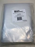 Packaged set of 100 Simple Houseware vacuum sealer bags in clear plastic packaging, showing texture and size.