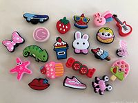 Image showing 20 assorted colorful shoe charms including animals, food, and accessories.