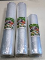 Front view of three rolls of vacuum sealer bags, two 30 cm rolls and one 20 cm roll, all wrapped in clear plastic with product labeling visible.
