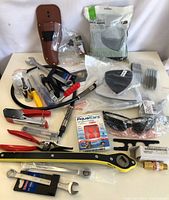 Wide view of lot showing variety of tools, hardware, safety items including face masks and glasses