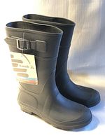 Front angled view of the new Kamik black rubber youth size 2 rain boots with tag showing brand name and logo attached.