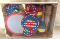 Melissa & Doug Band in a Box kids musical toy set in original packaging, showing multiple wooden percussion instruments for children.