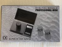 Photo of the digital scale box showing front with image of scale, weights, and instructions.