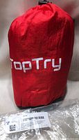 Red carry bag with 'TopTry' brand name containing the hammock