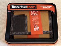 New Timberland men's trifold wallet in original retail packaging as seen from the top in tin box with branding and RFID protection label.