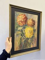 Photo showing angled front view of framed dahlia trio watercolour, highlighting frame detail and colours.