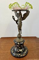 Full view of entire centrepiece showing bronze winged figure, glass bowl atop porcelain base