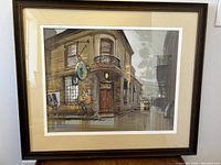 Framed oil painting front view showing pub scene and artist signature in lower left.
