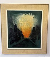 Front view of framed and matted colorful textured oil painting depicting a city skyline at sunset with bright orange and yellow sky and dark silhouetted buildings.