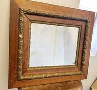 Full view of the rectangular oak wood frame and original mirror glass showing light age issues.