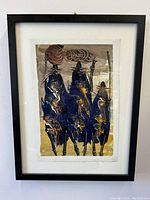 Frontal photo showing the entire painting inside a black frame with white mat, abstract art of three tribesmen in blue, brown, and orange hues.