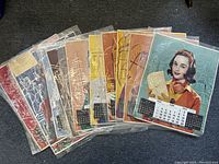Set of 11 vintage 1962 Timken Roller Bearing calendars with illustrated women and city backgrounds, displayed flat and in cellophane bags.