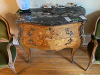 Full front view of commode with marble top and floral marquetry