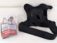 Adego posture corrector in original packaging alongside black DOACT reversible shoulder brace.