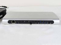 Front view of the Belkin Thunderbolt Express Dock showing connectivity ports including Ethernet, FireWire, two Thunderbolt ports, audio jacks, and USB 3.0 ports.