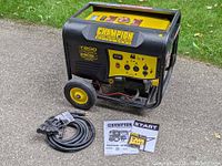Generator with cord and manuals arranged on pavement