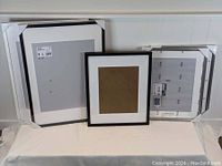 Four picture frames including two large RIBBA and two smaller SILVERHOJD frames displayed side by side on a flat surface.