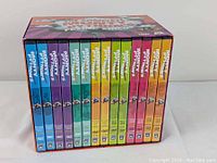 Front view showing the complete DVD collection with brightly colored DVD cases inside the box set.