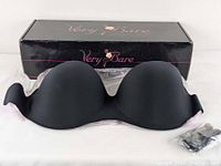 Black molded cup adhesive bra with no straps in front of a black rectangular box with 'Very Bare' branding.