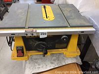 Full top view of the DEWALT table saw showing the metal table top with the saw blade opening and measuring ruler along the front edge.