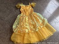 Yellow Disney Princess Belle costume dress laid flat on floor showing detail and length.