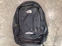 Front view of The North Face Vault black nylon backpack, showing logo and overall design