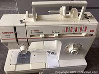 Front view of Singer Merritt 4530 portable electric sewing machine showing stitch pattern options, dials and threading area.