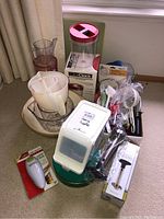 Wide view of all baking and kitchen supplies showing assortment of measuring cups, bowls, kitchen tools, and the Click Clack container.