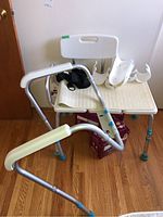 Photo of walker, shower chair, and orthopedic braces grouped together showing overall condition.