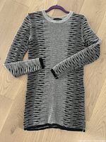 Front view of the black and white striped long sleeve cashmere blend sweater showing neckline, sleeves and body pattern.