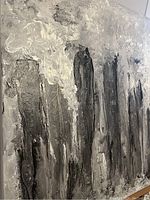 Close-up showing textured dark vertical forms with white and grey abstract cloud-like elements in an acrylic cityscape painting.