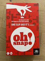 Front cover of the Oh Snap! game box showing title, brand, and tagline.