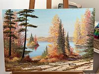 Front view of original Cole Bowman landscape painting showing tranquil lake and autumn trees, signed in lower right.