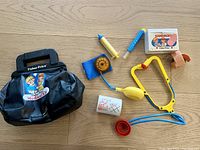 Full view of the vintage Fisher-Price medical kit items laid out with soft carrying case and all accessories included.