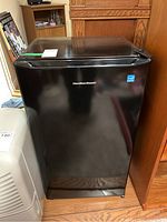 Front view of black Hamilton Beach bar fridge