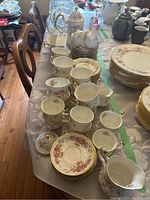 Overview of cups, saucers and plates stacked on table