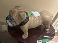 Side view of ceramic bulldog figurine showing size and texture.