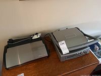 Cuisinart griddle next to FoodSaver vacuum sealer on wooden surface