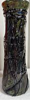 Full tall view of textured stained glass vase showing dark iridescent colors and glossy finish.