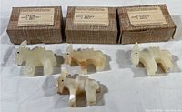 Four onyx miniature donkey figurines displayed with original labeled boxes, showing the size and variety of the items.