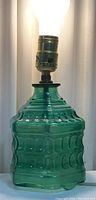 Full view of the vintage green glass lamp base showing textured glass pattern and lamp socket.
