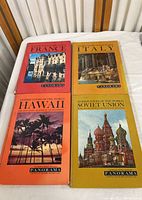 Four vintage travel books from the Panorama series laid out, featuring France, Italy, Hawaii, Soviet Union covers.