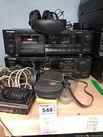 Front view of Pioneer CT-S601R cassette deck and VSX-5900S receiver stacked. Headphones, remotes, and multiple cables visible on shelf.