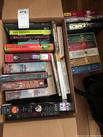 Top view photo of box containing mixed paperback books and some hardcover books; Ian Rankin visible on a bright green spine, James McBride, plus other titles