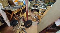 Overview of natural wood finish drums, Zildjian cymbal bag and chrome hardware in basement workspace